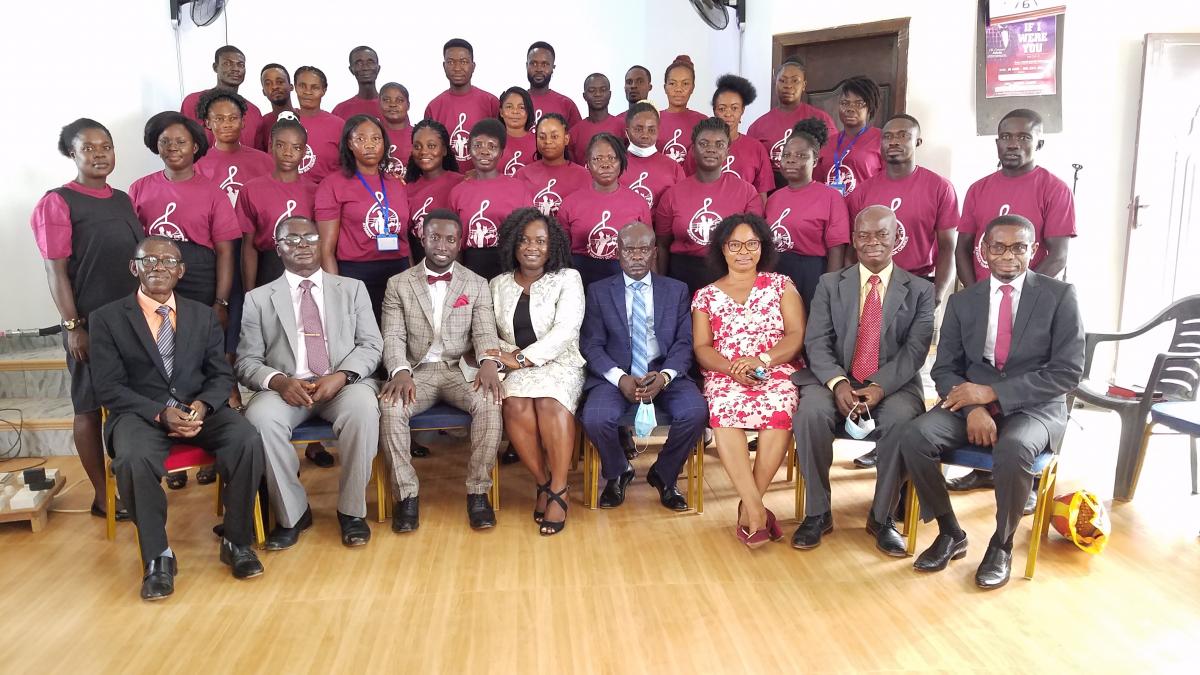 The Asiedus (seated second from left) are surrounded by Ghanaian church leaders and volunteers.