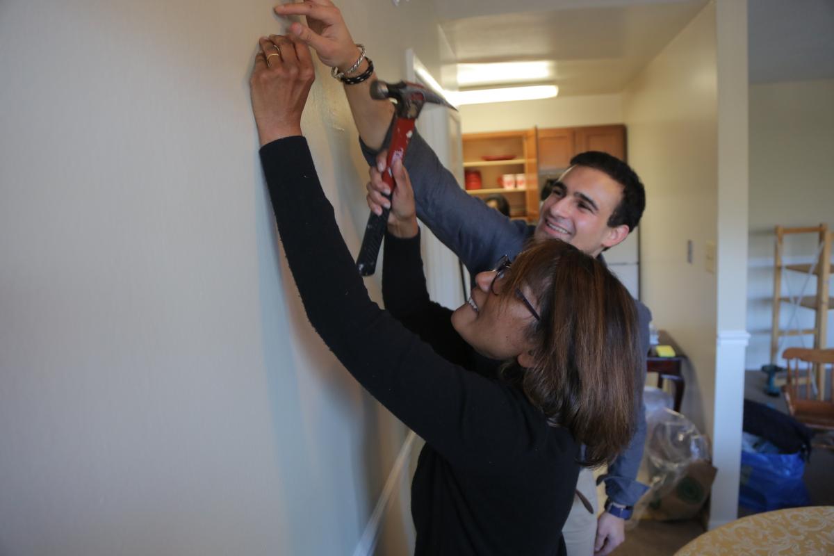 Hannah Koilpillai and Nicholas Grossman, who both attend Sligo church, help prepare a home for a family from Afghanistan.