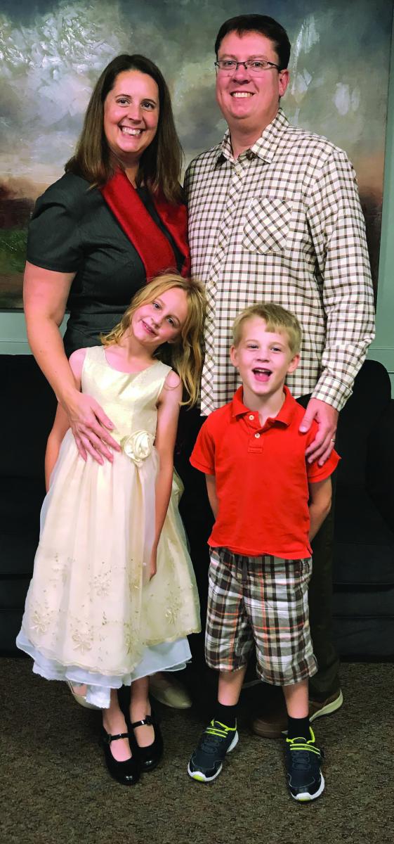 Pastor Heather and Eric Crews pose for a family picture with Molly and Owen.