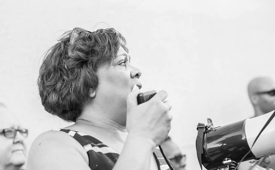 Debra Anderson speaks at a march where a thousand Adventists gathered. | Photo by Richard Gordon