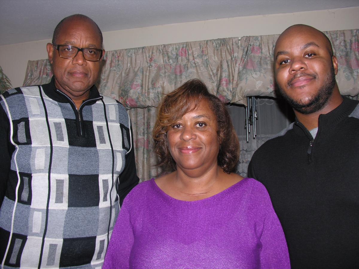Cindy Washington is pictured with her husband, Kenneth, a pastor, and their son, Kendrick.