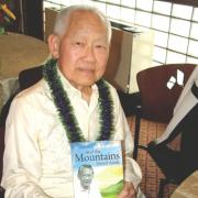 Vernon Luthas, MD, is pictured holding a copy of his autobiography And the Mountains Stood Aside.