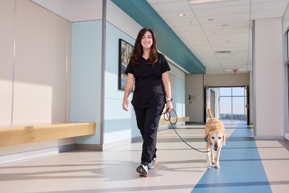Heather Tropiano, a rehabilitation psychologist at Adventist HealthCare Rehabilitation at White Oak Medical Center, says Peru, a golden Labrador cross, is an active partner in helping patients through rehab.