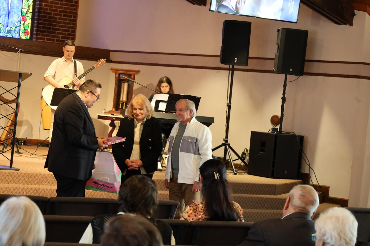 Pastor Gennadii presenting a gift on behalf of the church to a Ukrainian couple who were returning to Ukraine. 