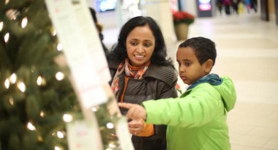 A mom and her son pick a child to sponsor from the Angel Tree.