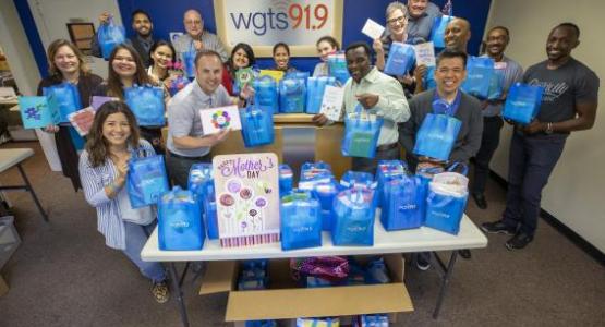 WGTS Staff poses with bags of Mother’s Day cards before going out to deliver.