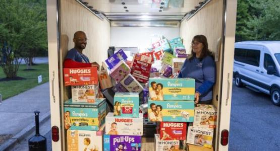 WGTS 91.9 Hands and Heart volunteers Eric and Pat organize diapers in the box truck.