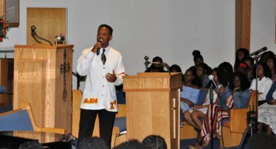 At the back-to-school revival, alumnus Garnett Adams (’10) speaks to PFA students about how God saved him during his incarceration.