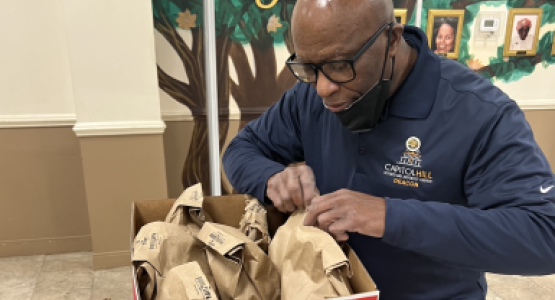 Robin Sampson, head deacon at the Capitol Hill church, packs bag lunches during the “Acts of Kindness” day.