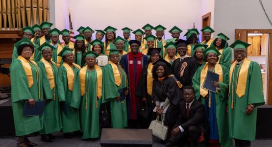 Speker Antoine (center), guest speaker at the Bethel French church’s inaugural promotion service, is flanked by the graduates, pastor and church leaders. Bethel French Graduates 32 at Promotion Service, Bethel French church, Allegheny East Conference, Speker Antoine, Abdonel Jean Philippe, Voice of Hope