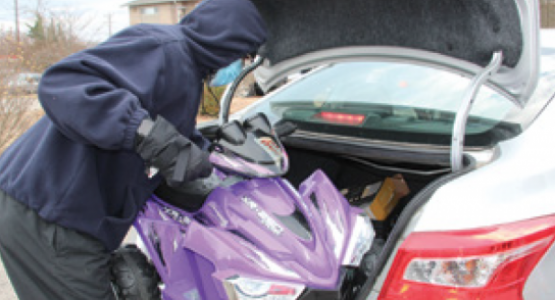 A volunteer places a toy in a car to bring joy to a child.