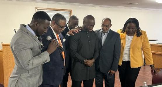 Columbia Union Conference, Allegheny East and NAD officers pray with Trevor Kinlock, the new president of the Allegheny East Conference.