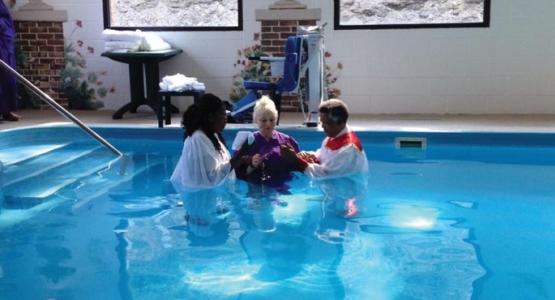 Rosalind Beswick and Carl Rogers help Susan Riddle (center) prepare for her baptism. Rosalind Beswick and Carl Rogers help Susan Riddle (center) prepare for her baptism.