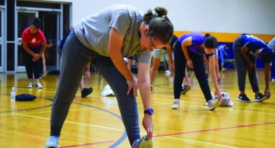 Senior Annelise Jacobs starts the day off stretching as part of this school year’s morning workout. Senior Annelise Jacobs starts the day off stretching as part of this school year’s morning workout.