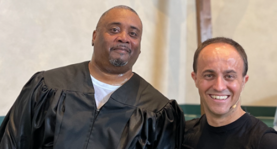 Diego Boquer, senior pastor of the Baltimore-White Marsh church, baptizes Travis McClurkin.