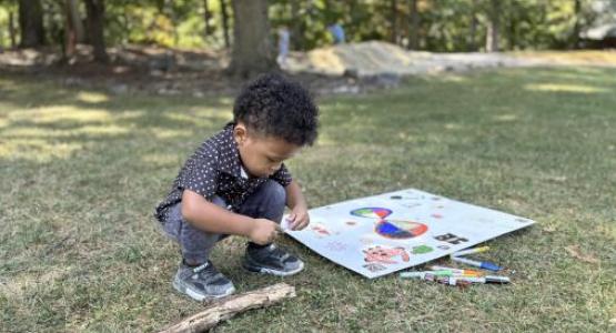 A toddler spends time in nature during Beltsville church's Sabbath outing at the Mt. Aetna Retreat Center.