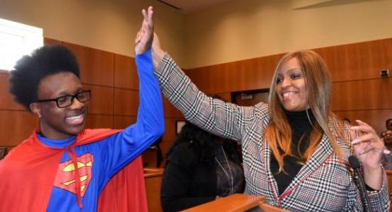 Lorene Watkins, Mt. Olivet’s Relationship Ministries leader, gives a high five to a fifth-grader from a local public school who played the “Superman” defendant during a mock trial. Photo by April Saul