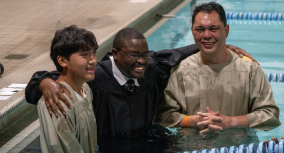 Elvis Mogoi (center), pastor of the Baltimore-White Marsh church, baptizes Renzo (left) and Ricky Pajaron. Elvis Mogoi (center), pastor of the Baltimore-White Marsh church, baptizes Renzo (left) and Ricky Pajaron.