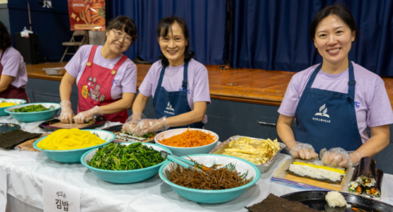 Washington-Spencerville Korean church members Seon Young Park, Gwi Young Jeong and Sarah Kim (left) serve food during the community expo, while My Life Foundation representatives (above) staff their health booth. Washington-Spencerville Korean church members Seon Young Park, Gwi Young Jeong and Sarah Kim (left) serve food during the community expo, while My Life Foundation representatives (above) staff their health booth.