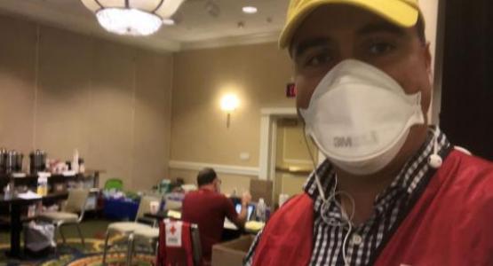Adventist Community Services director for Chesapeake Conference, Ignacio Goya, stands in the processing center for evacuees arriving in the United States through Dulles International Airport. 