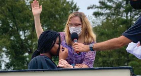 Debbie Rivera, associate pastor of the Ellicott City church, baptizes Meghan Stewart into the church.