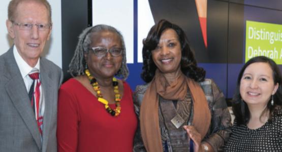 Deborah A. Hill (third from left), Southeast church mem- ber, receives the 2017 Distinguished Alumnus Award and celebrates with John A. Yankey, Case Western Reserve University professor; Sharon E. Milligan, associate dean; and Annette Iwamoto, alumni president.