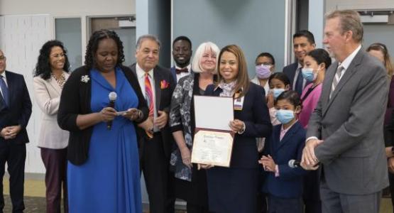 Adventist HealthCare Chaplain Denny Renifo celebrates reciting her ordination credentials. Photo courtesy Adventist Healthcare