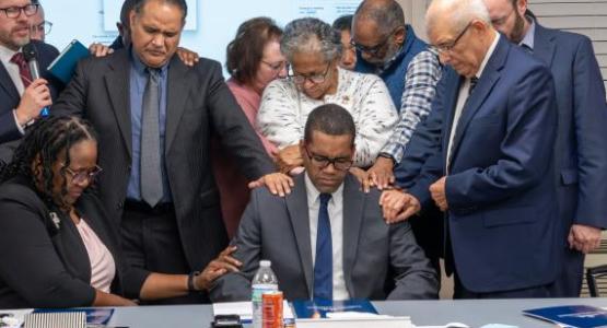 The Chesapeake Conference Executive Committee prays for Andre Hastick following his election. Photo by Melvin Donadelle