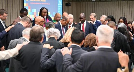 Columbia Union Conference Executive Committee members pray over President Marcellus T. Robinson. | Photo by Kelly Butler Coe