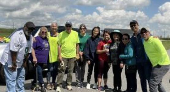 Junnie Ree Pagusan (right), pastor of the Far West End church, along with 10 other members, take a break in the middle of cleaning the surrounding church area.