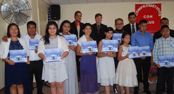 New members display their baptismal certificates.