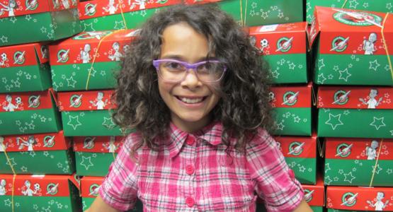 Project director Adilynn woods poses with the completed shoeboxes. 