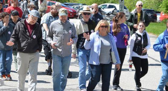 William Levin (middle with cap), pastor of Akron First, and his wife, Jan, lead their church members in the "Walk to Stop Hunger" campaign