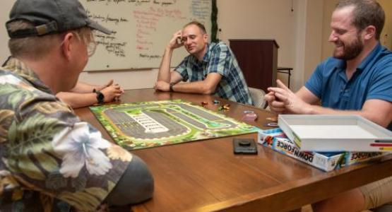 Scott Kabel (right) plays weekly board games with church and community members. Photo by David Butterfield