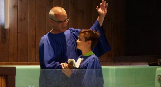 Jeremy Garlock, pictured baptizing a student, believes Adventist education is an important tool for impacting the lives of children and sharing the gospel with families who are not yet attending church.