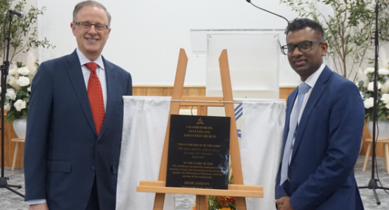 President Gary Gibbs and Pastor Murvin Camatchee unveil a plaque commemorating the dedication of the Chambersburg church.