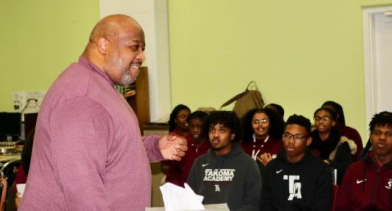 Stacey Gibbs, a composer and arranger of spirituals, shows the TA chorale a different arrangement to one of his songs.