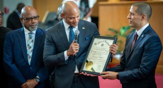 Maryland Governor Wes Moore gives Takoma Park church pastor Daniel Xisto a citation for their community service as Potomac Conference president Charles Tapp looks on. Image courtesy North American Division of Seventh-day Adventists