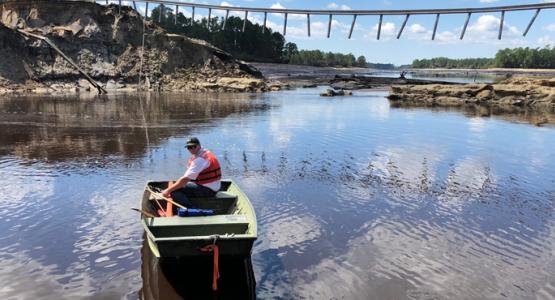 Tracy Hendren, Savannah District Engineering Division Chief, traverses the water to inspect the washout of Boiling Springs Dam, N.C. Sept. 19 after Hurricane Florence. The object stretching across the divide is the guard rail of the road that once passed over the dam. (U.S. Army Corps of Engineers photo)