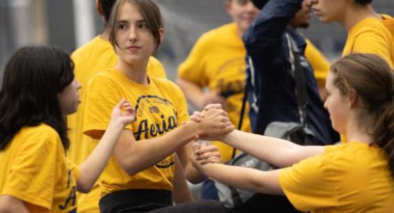 Freshmen Aerials Julianne Paris, Samantha Bitner and Karen Gomez learn a new move.