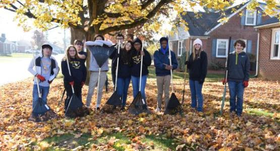 Students prepare to rake leaves in Highland View Academy’s community.