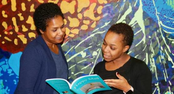 Math teacher D’Anya Brezzell (right) shares her thoughts about Kelli Raí Collins’ new devotional book.