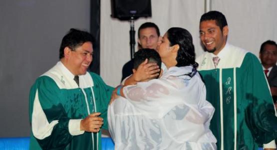 Lail Fuentes (left), pastor of the First Columbus Spanish church, and Enmanuel Freites (right), pastor of the Dayton Spanish church, baptize one of five people during the 2018 Ohio Conference Hispanic Camp Meeting.