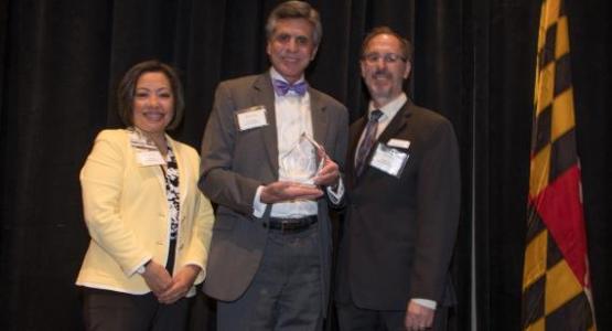 John Sackett, Executive Vice President and Chief Operating Officer for Adventist HealthCare, and Ann Roda, Vice President of Mission and Spiritual Care for Adventist HealthCare, accept the Interfaith Works 2019 Philanthropic Champion of the Year Award from CEO Shane Rock during an April breakfast.