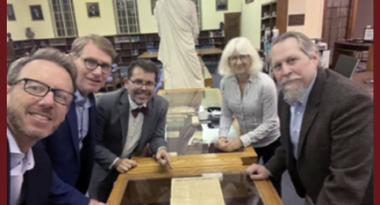 Jonathan Scriven, Nicholas P. Miller, Michael W. Campbell, Kathy Hecht, and Bradford Haas take a photo of the document with historical ties to the founding of the Seventh-day Adventist Church. [Photo: courtesy of Michael Campbell]