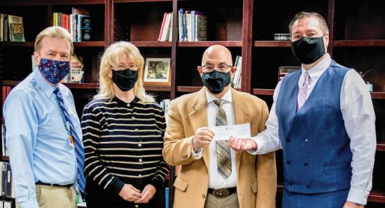 Charla and Steve Scovil present a check from Bob Scovil’s estate, flanked by Planned Giving Director Harry Straub (left) and Ohio Conference President Bob Cundiff. Charla and Steve Scovil, Harry Straub, Bob Cundiff