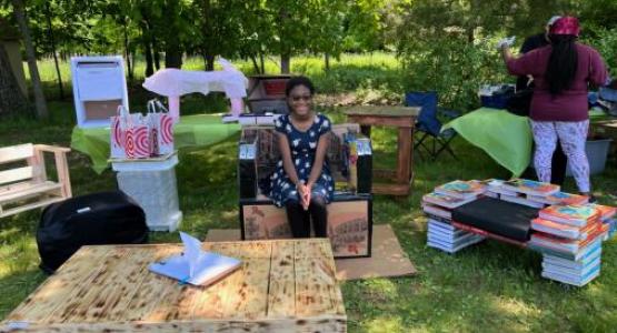 Sixth-grader Sobrina Sterling sits on a piece of furniture made by the 11th grade physics class. Sixth-grader Sobrina Sterling sits on a piece of furniture made by the 11th grade physics class.