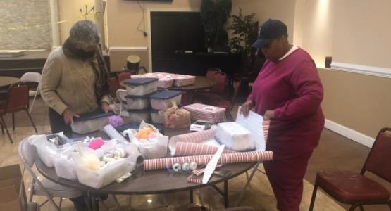 Vivian D. Walker and Deborah Y. Davids, team members from the Women’s Ministries Department at First church, wrap shoeboxes filled with donated personal items. Allegheny East Conference, First Church, Shoebox Gift Project, My Sister's Place