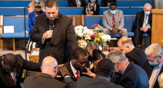 President Bob Cundiff (standing) and other church leaders pray over the life and ministry of Delthony L. Gordon (center), senior pastor of the Beavercreek church. Ohio Conference, Delthony L. Gordon, Beavercreek Church