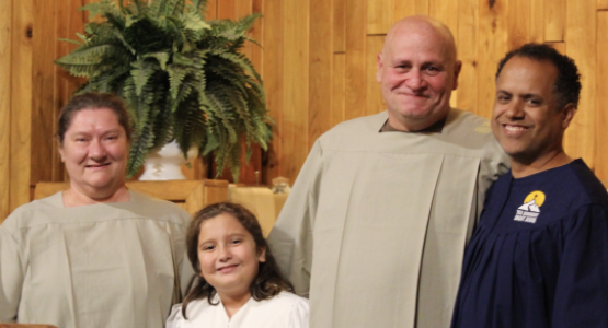 Jaime Rodriguez (right), pastor of the Summersville church, introduces baptismal candidates Amy Perdue (left), Brayleigh Lafferty and Jackie Perdue to the congregation. Photo by Jenny Rodriguez Jaime Rodriguez (right), pastor of the Summersville church, introduces baptismal candidates Amy Perdue (left), Brayleigh Lafferty and Jackie Perdue to the congregation. Photo by Jenny Rodriguez